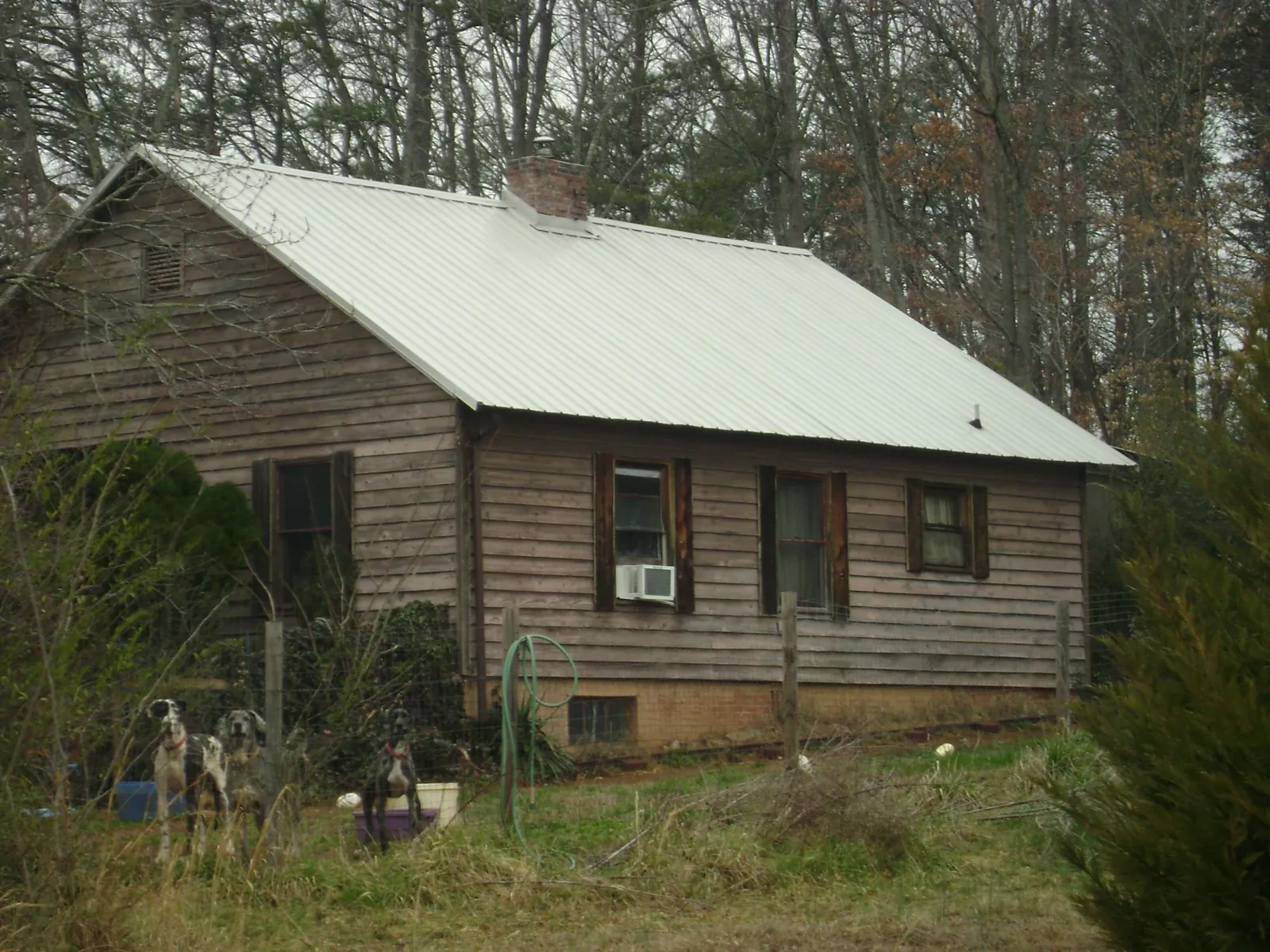 White metal roof on an old wood sided farmhouse, from a Metal Roof Installation job in North Troy